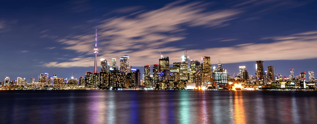 Toronto skyline at night reflecting on Lake Ontario